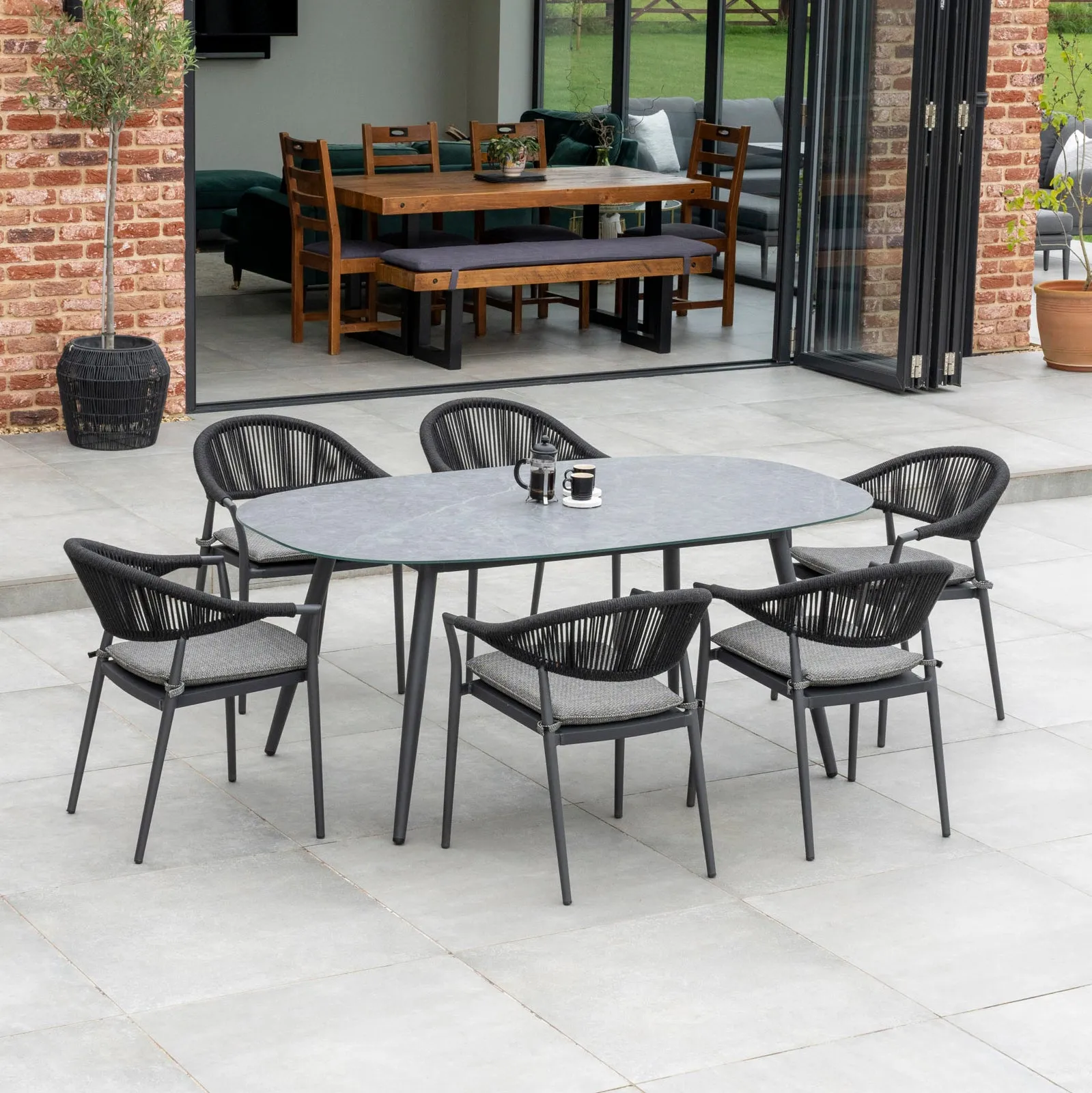 Cloverly 6 Seat Rope Oval Dining Set with Ceramic Table in Charcoal